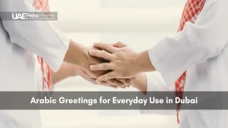 Two men in national attire clasping hands demonstrating traditional Arabic greeting.