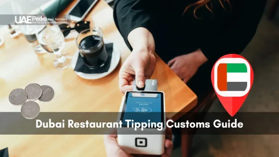 Payment at a Dubai restaurant with card terminal, Emirati coins, and coffee visible