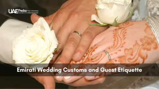 Bride and groom’s hands—one with intricate henna—holding white roses during wedding ritual.