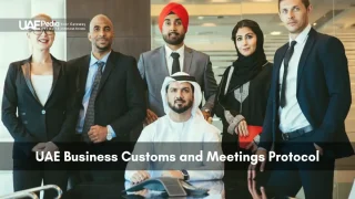 Emirati man and international colleagues dressed in business attire stand together in office.