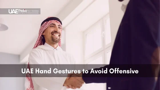 Emirati man smiling and shaking hands to show friendly respect.