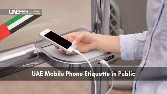 Close-up of mobile phone being charged in a UAE public charging station.