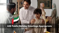 Man and child exchanging greetings at home with UAE flag during holiday celebration