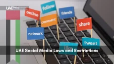 Flags reading network, comment, share, tweet on keyboard hint at UAE social media laws.