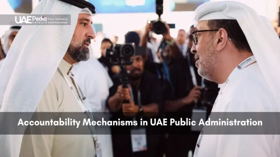 Two UAE officials in traditional attire speak face-to-face while media capture their discussion in a conference setting
