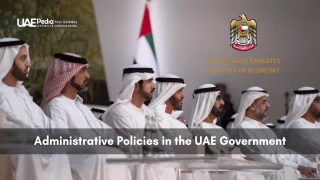 Emirati dignitaries in kanduras seated in a formal meeting room with Ministry of Economy emblem displayed above them