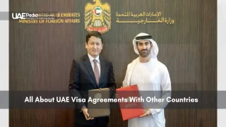 Officials from UAE and another country holding agreement folders