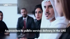 UAE men and women in formal attire engaged in a focused business discussion.