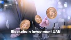 Business professional presenting a Bitcoin against the UAE skyline, symbolizing Blockchain investments.