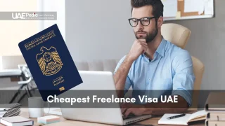 Man in glasses seated at desk typing on a laptop with a floating UAE passport icon.