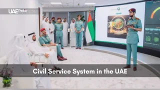Uniformed officer using tablet to present performance dashboards to seated Emirati leaders