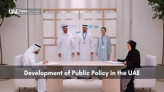 Emirati and global representatives seated at a table signing documents under COP28 UAE signage