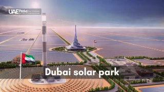 Bird's eye view of Dubai solar park with solar panels and central monument.