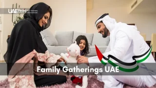 A happy family in traditional Emirati attire playing with a child in the UAE.