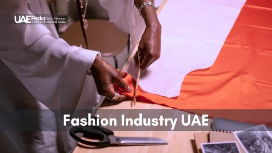 Designer cutting fabric, showcasing UAE's thriving fashion industry.