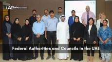 Men and women of various backgrounds standing together at a UAE federal meeting.