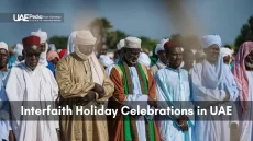 A diverse group of people united in prayer, representing interfaith harmony in the UAE.