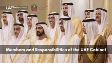 UAE ministers wearing kanduras and bishts standing in rows during an official event.