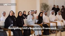 Group of Emirati professionals at a forum discussing UAE regulations beneath UAEPedia logo