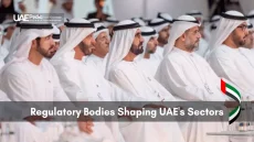 Group of senior UAE regulators in kanduras seated in rows at a conference on shaping national sectors