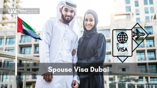 Emirati husband and wife pose outdoors in Dubai Marina with floating visa and UAE flag icon.