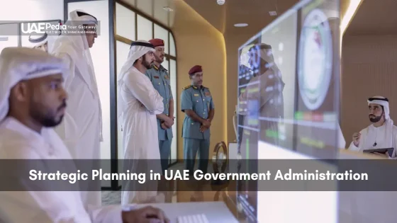 Group of Emirati dignitaries and uniformed officers gathered around monitors displaying government metrics