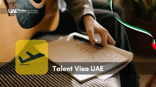 Hand writes song lyrics in a notebook while an acoustic guitar and visa icon appear nearby.