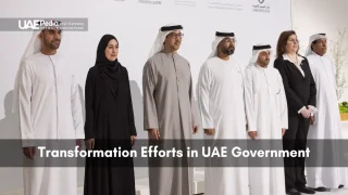 Men and women in traditional and formal attire posing at a UAE government event.