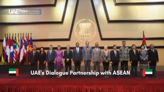 Delegates standing in front of ASEAN logo at UAE-ASEAN partnership event