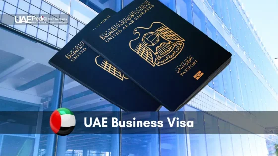 Close-up of UAE investor visa application form next to a passport, leather wallet, and smartphone