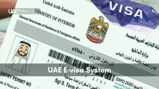 Close-up of UAE e-visa entry permit showing barcode, emirate emblem, and personal photo placeholder.