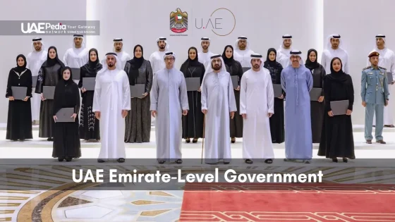 Men and women UAE officials standing in traditional dress in a formal government hall.