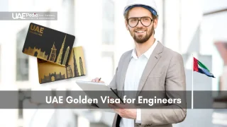Male engineer wearing a hard hat holds a tablet next to two black-and-gold UAE Golden Visa cards.