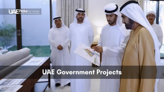 Emirati leaders in traditional attire review printed government project plans indoors
