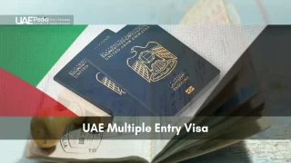 Two UAE passports stacked on an open passport showing visa stamps with flag colors in background.