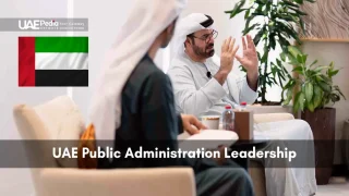 Two men in traditional Emirati dress seated, discussing leadership topics.