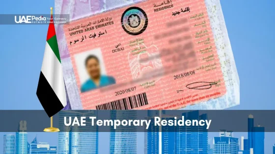 Temporary UAE residence permit card displayed over skyscraper skyline with a small national flag.