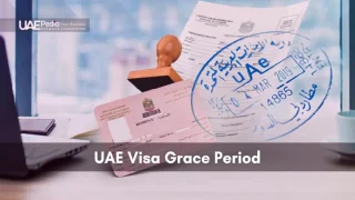 Close-up of a blue UAE entry stamp over a pink residence visa card beside a laptop.
