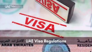 Close-up of a red “VISA” stamp on United Arab Emirates residence permit papers.