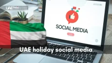 Social media and UAE flag displayed on a laptop screen, celebrating holidays.