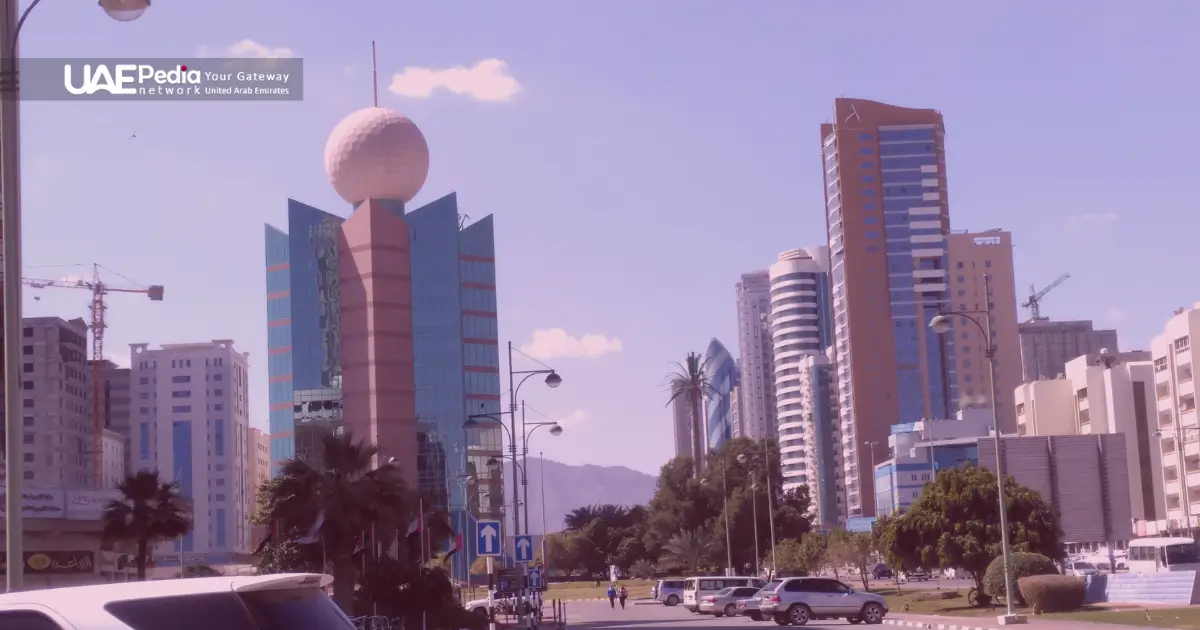 Fujairah city street with skyscrapers and a unique spherical tower.