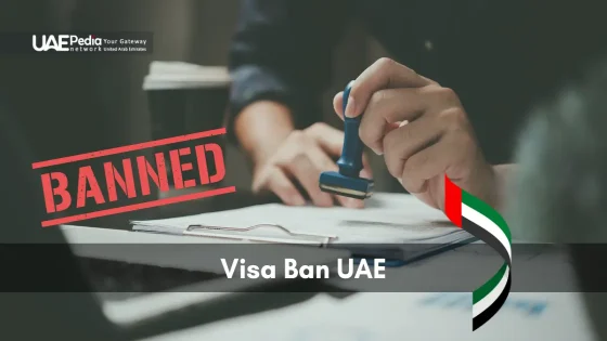 Hand presses a stamp on paperwork marked “BANNED,” illustrating a UAE visa ban.