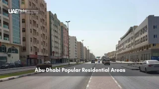Abu Dhabi residential street with mid-rise buildings and light traffic
