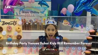 Smiling girl at a donut-themed birthday party with colorful decorations