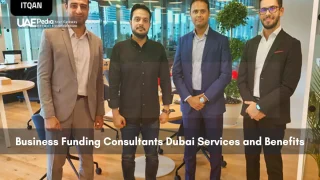 Four men in business attire standing in a modern Dubai office space