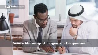 Two men discussing documents in a mentorship meeting