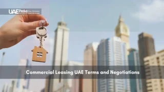 Hand holding a key with a city skyline background