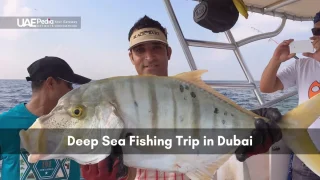 Man smiling aboard a boat holds a huge fish with crew photographing the catch under clear sky