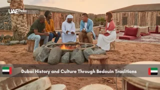 Tourists sitting with a local Emirati around a desert campfire