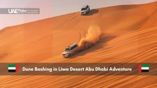 Cars dune bashing in Liwa Desert with sand flying